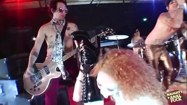 A girl becomes aroused, utilizes a dildo at a shop, and participates in a threesome on stage