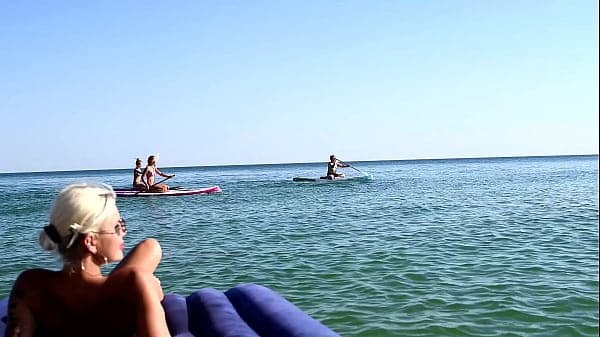 I spy on the beach as a girl with big boobs sun...